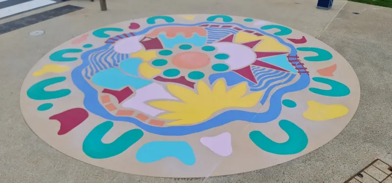 Circular Aboriginal artwork medallion applied to pavement