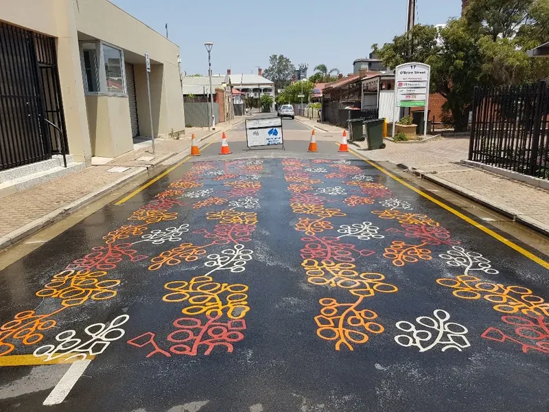 Gold red and white decorative pattern along a shopping strip street