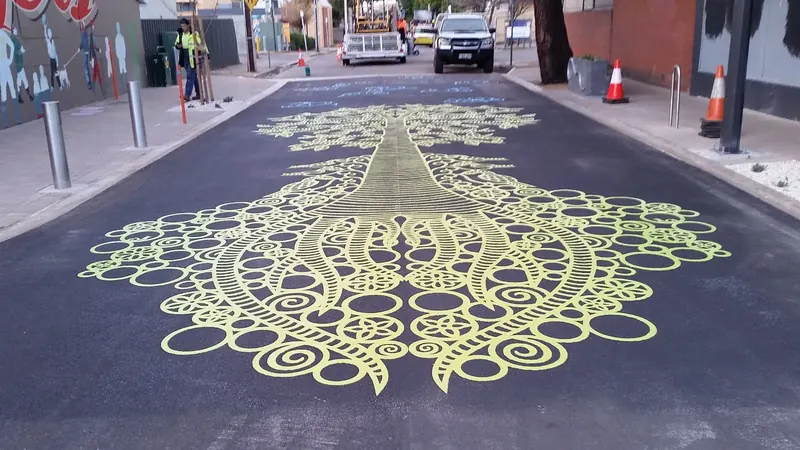 Gold lace DuraTherm pattern melted into an asphalt road