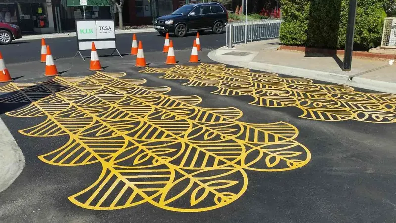 Gold leaf pattern decorative asphalt treatment on a city street