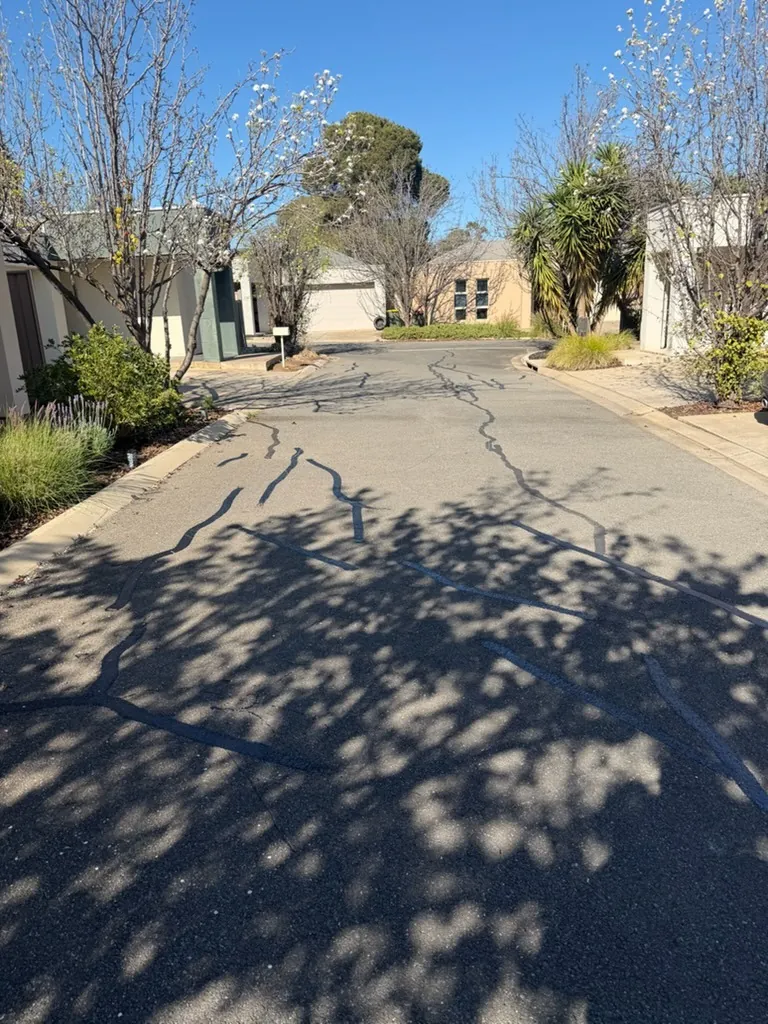 Hot applied crack sealing on a residential street protecting the pavement base