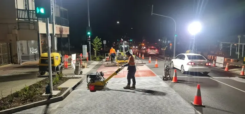 Creative Pavements crew applying coloured surfacing during night works
