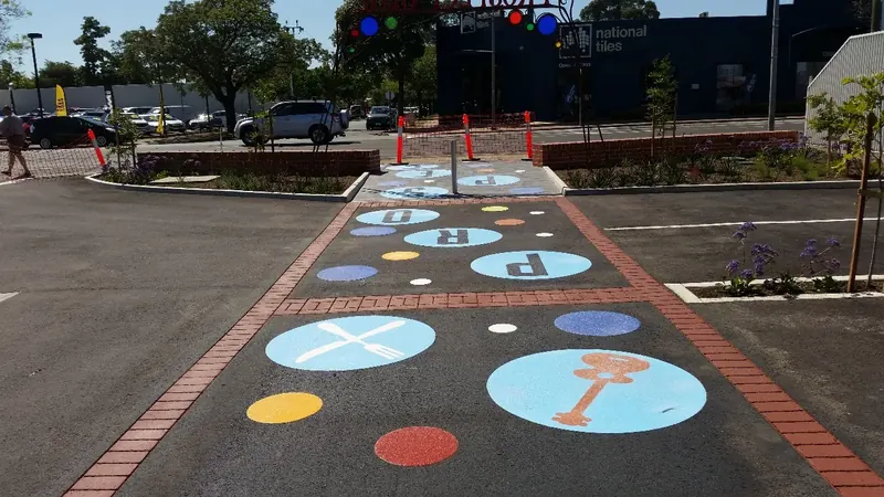 Colourful letter dots decorating parking bays at Prospect