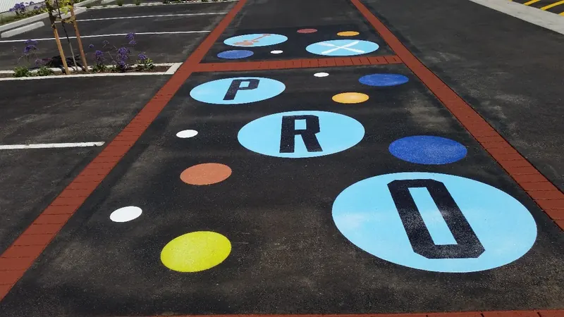Prospect spelled in playful dots across black asphalt