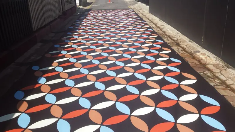 Retro circle pattern in orange blue and white along a laneway
