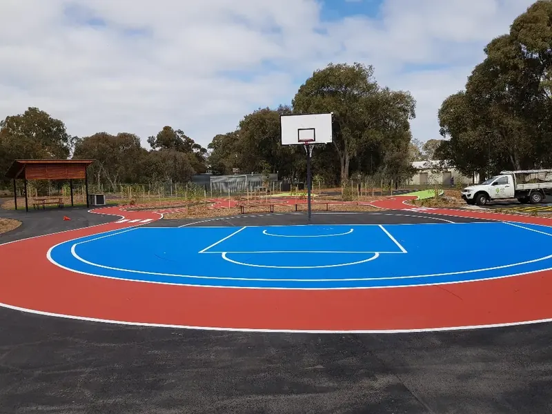 Basketball court surfaced in red and blue StreetBond