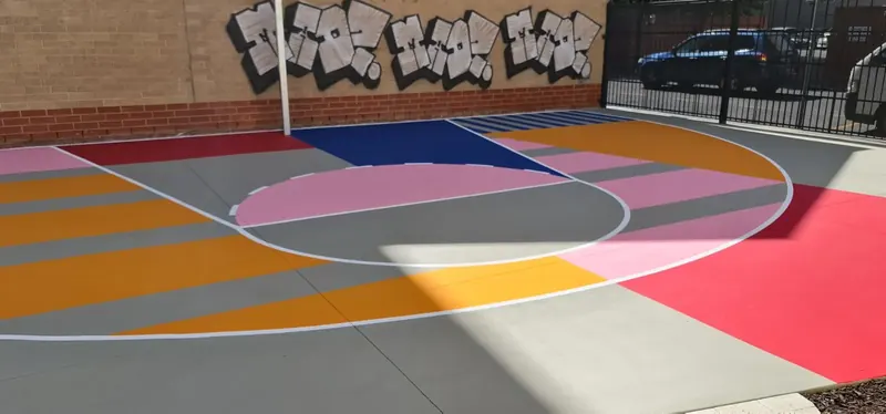 Geometric StreetBond court in pink blue and orange at a school