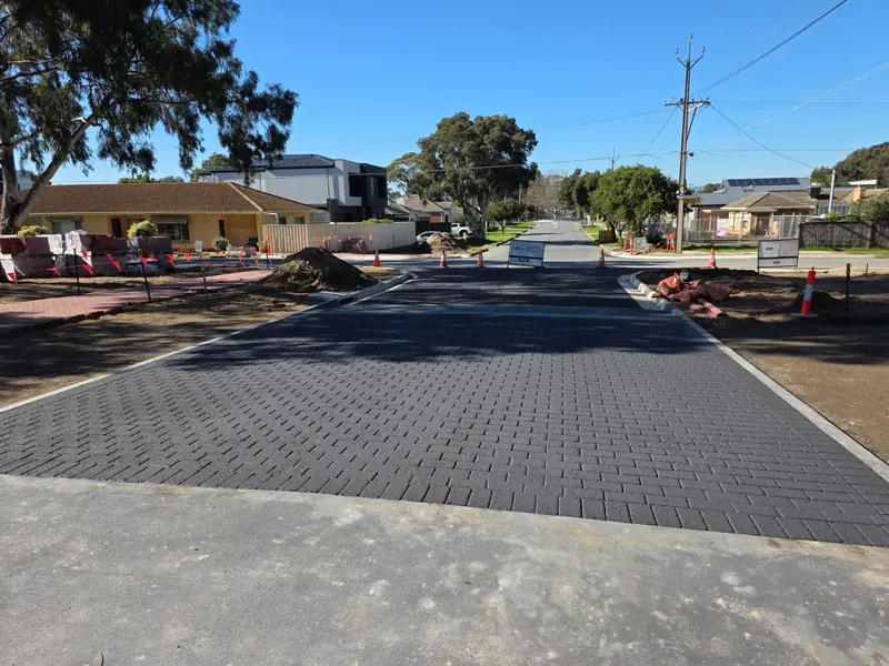 Charcoal brick pattern stamped asphalt road under construction