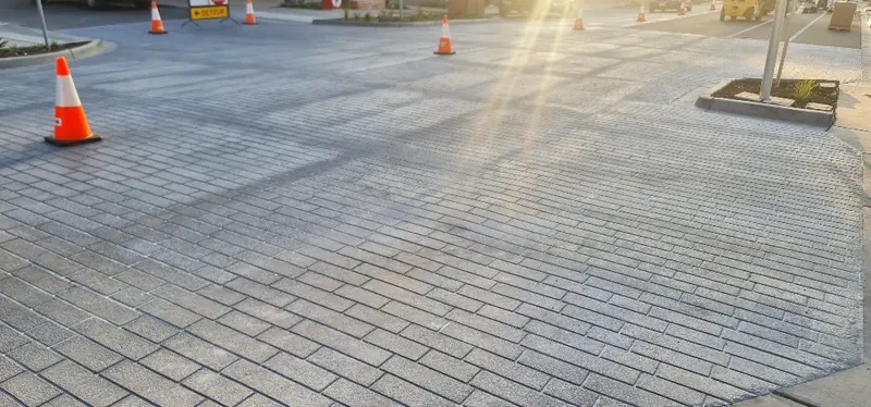 Light grey cobblestone StreetPrint intersection in morning sun