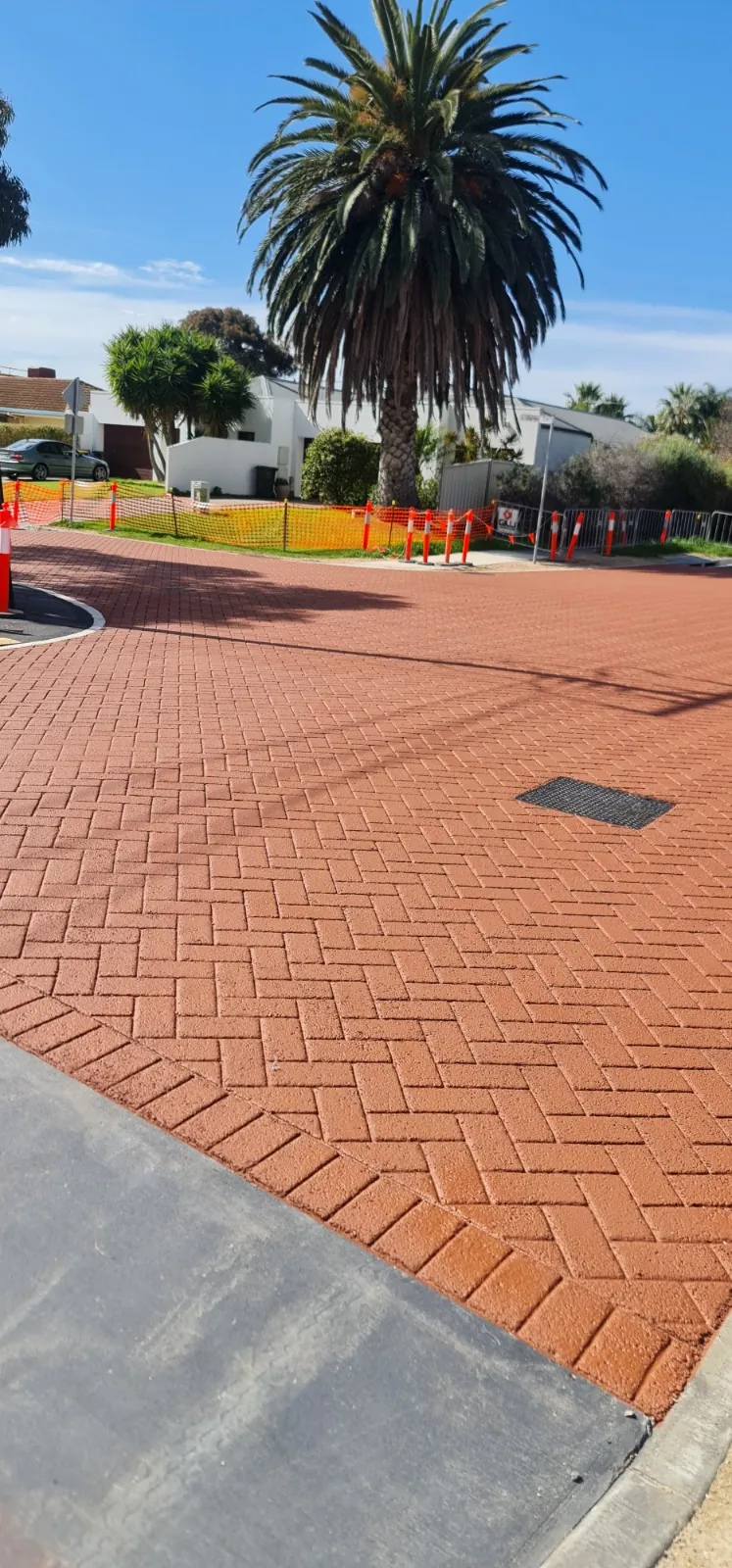 Red herringbone brick pattern stamped asphalt path