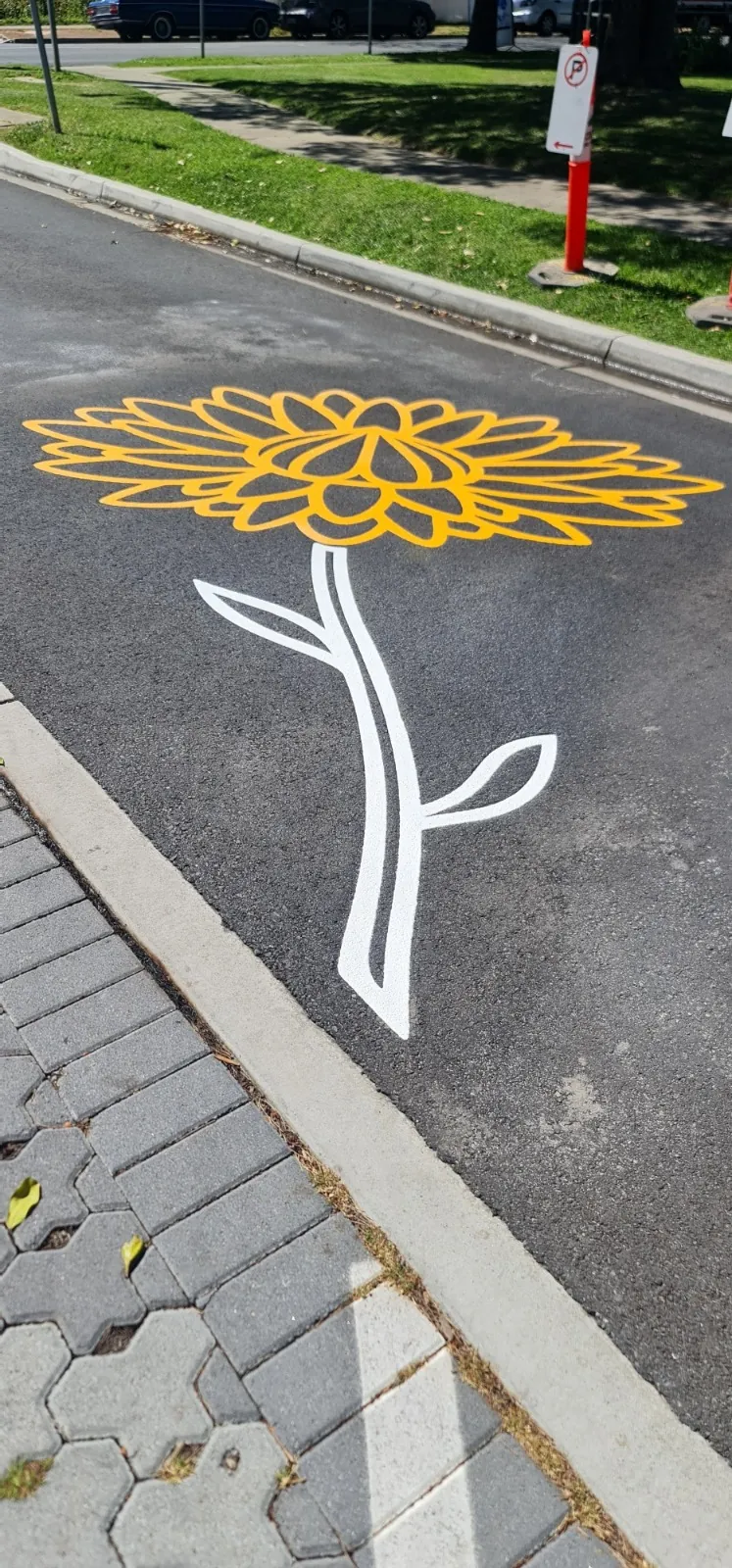 White flower stem pattern detail beside a kerb