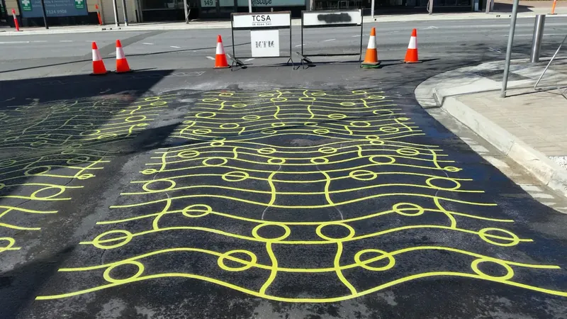 Yellow wave and circle pattern across a road